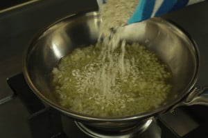 adding rice to onions