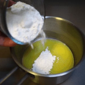 making roux by mixing flour and butter