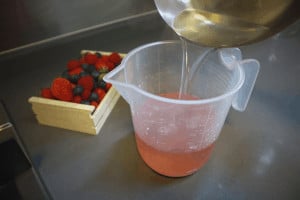 mixing sugar syrup in pink champagne
