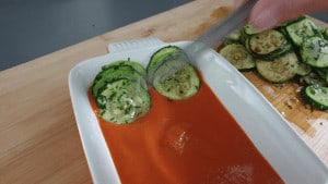 plating slices of marrow in tomato sauce
