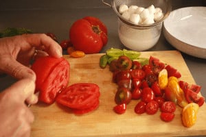 cutting mixed tomato salad