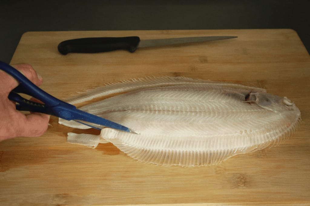 cut the fish bones from the fish with scissors
