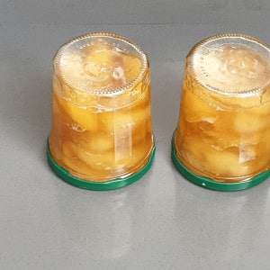 put sterilized jars with peaches upside down