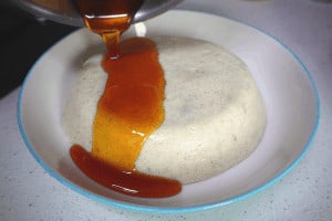 pouring caramel over semolina pudding
