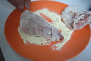 coating pieces of rabbit in semolina
