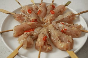 raw chicken on bamboo skewers before bbq