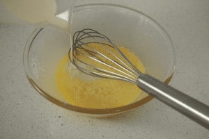 mixing egg mixture with cream