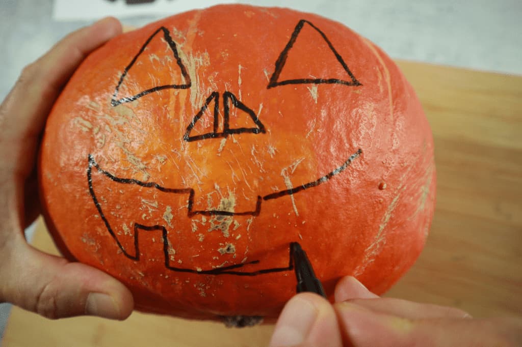 design a scary face on a pumpkin