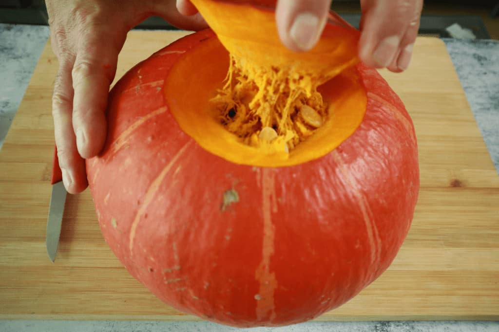 cutting the head of a pumpkin
