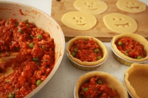 filling pies with bolognaise