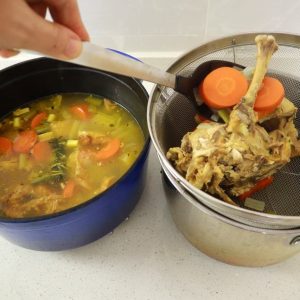 straining chicken stock