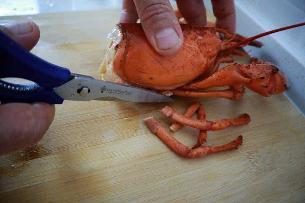 poached lobster cutting the legs