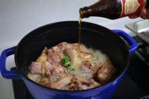 adding beer to rabbit stew