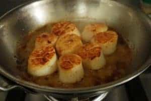 scallops in a stainless steel pan