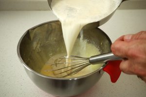creme anglaise adding warm milk to egg mixture