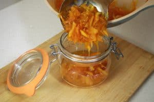 filling jars with orange marmalade