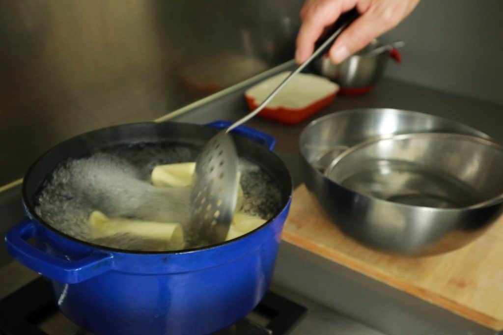 stirring pasta in boiling water
