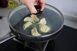 covering dumplings in teflon pan