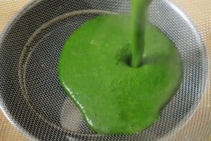 sieving coconut spinach soup