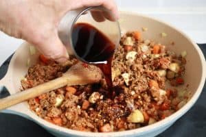 vegan bolognaise sautéing vegetables with vegan meat