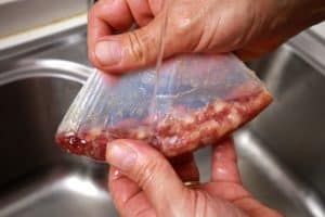 peeling the casing of a sausage
