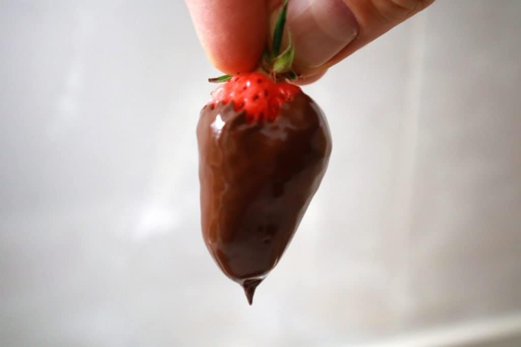 dipping strawberry in chocolate