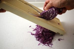 shredding red cabbage with a mandoline
