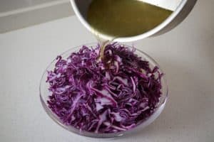 pouring vinegar over red cabbage