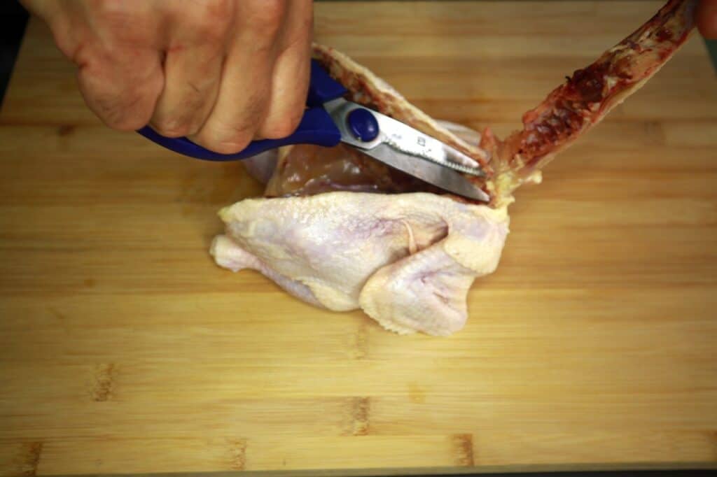 cut the spine from the chicken