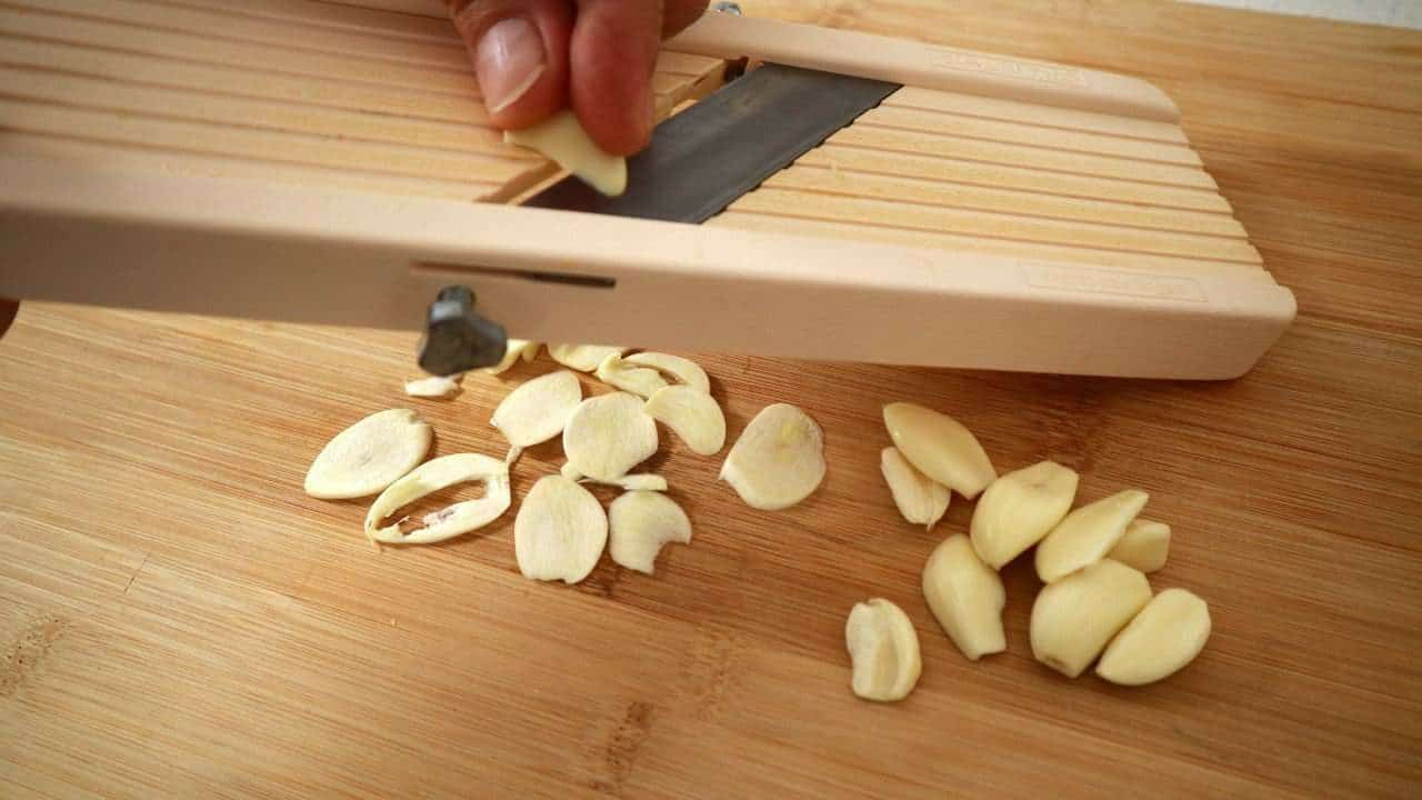 slicing garlic to make garlic chips