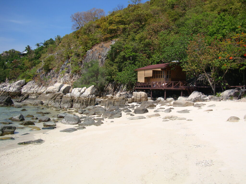 a desert beach with a wooden hut